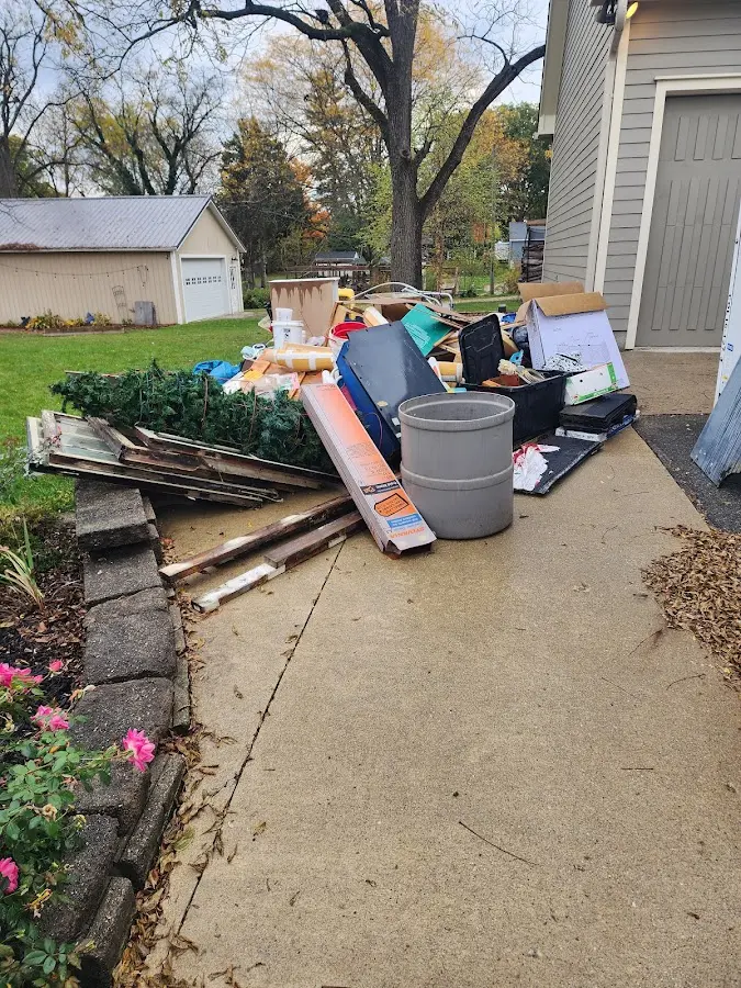 Dumpster being loaded with debris for Estate Cleanout Dumpster Rental in Perry
